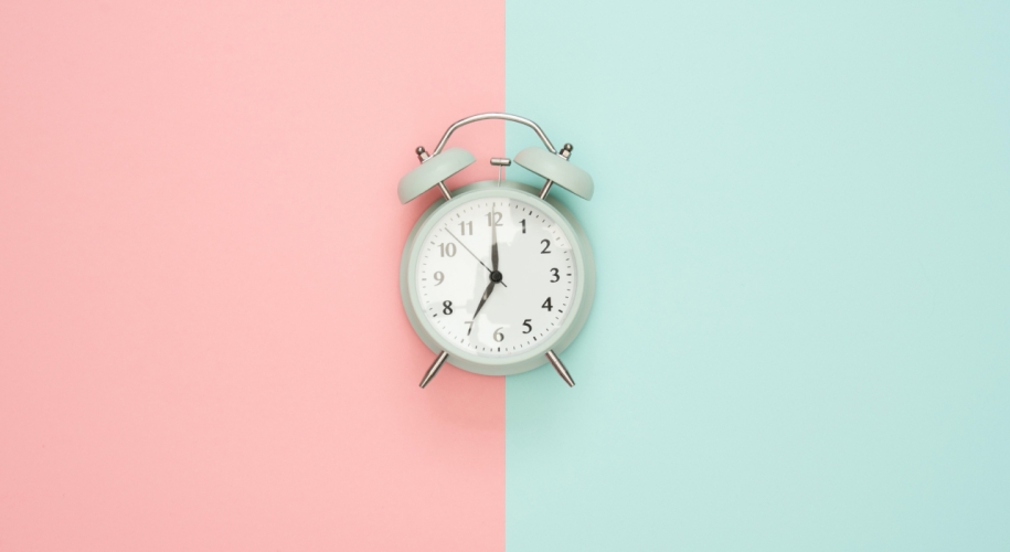 Picture of a clock with 2 soft colors (pink and blue) contrasting with each other.